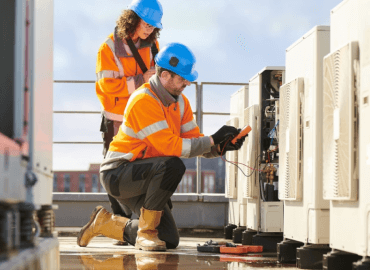 A Photograph of a Male Engineer and a Female Engineer Testing Electrical Signals Using Multimeters